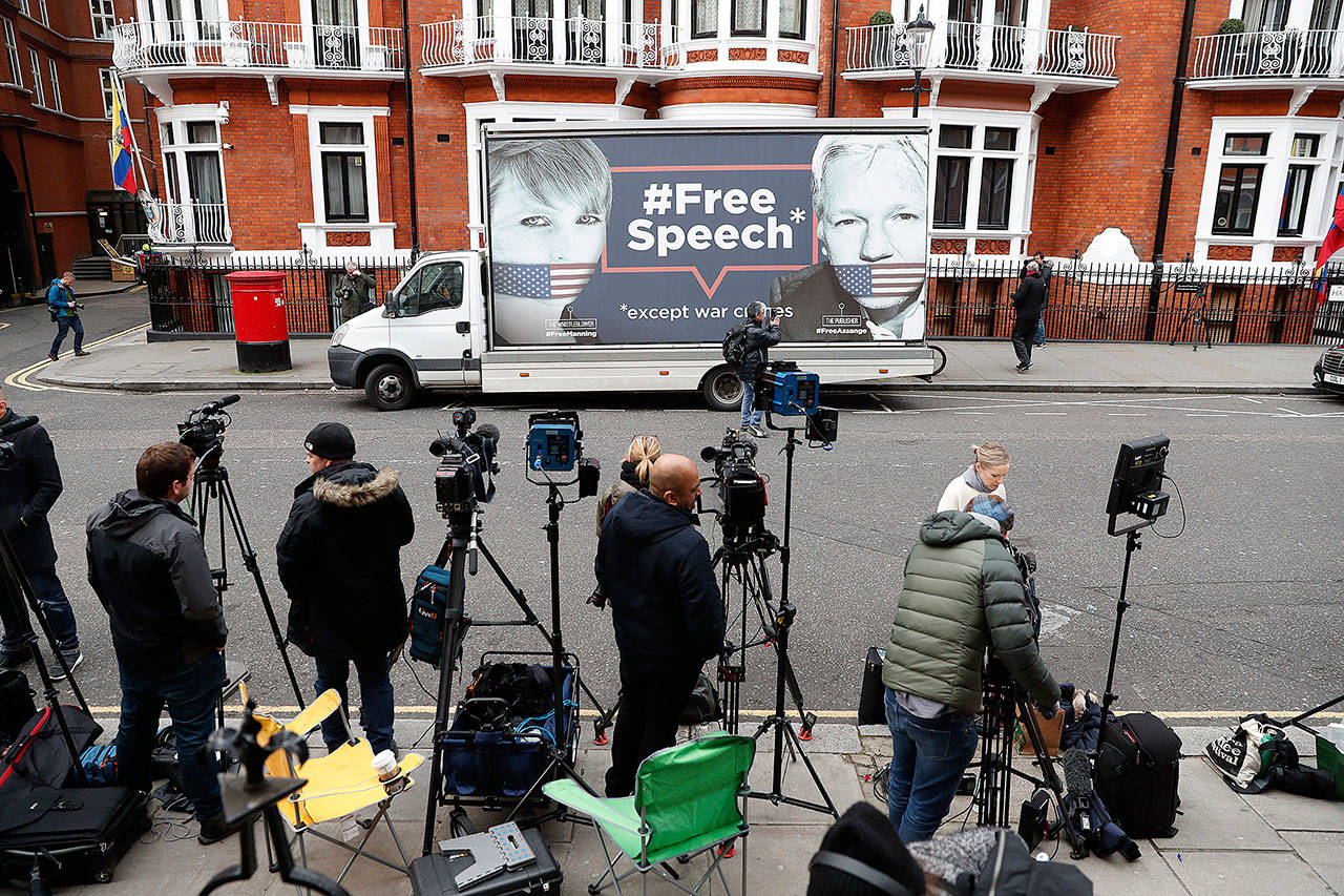 A van with a ‘Free Speech’ placard and the images of Wikileaks founder Julian Assange and Chelsea Manning on its side, is parked outside the Ecuadorian Embassy in London on Friday where Wikileaks founder Julian Assange has been holed up since 2012. (AP Photo/Alastair Grant)