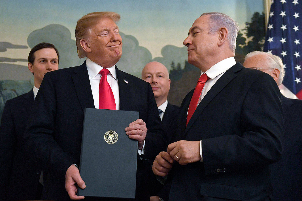 President Donald Trump smiles at Israeli Prime Minister Benjamin Netanyahu after signing a proclamation in the Diplomatic Reception Room at the White House in Washington on March 25. Trump isn’t on the ballot for Israel’s national election, yet he’s a dominant factor for many American Jews as they assess the high stakes of balloting on Tuesday, April 9, 2019. (AP Photo/Susan Walsh)