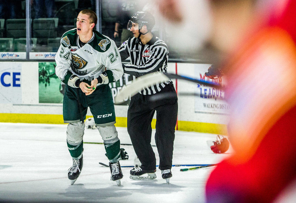 Silvertips’ Gianni Fairbrother is escorted off the ice by a referee after a fight breaks out after the buzzer during the game against the Spokane Chiefs on Sunday, April 7, 2019 in Everett, Wash. (Olivia Vanni / The Herald)

