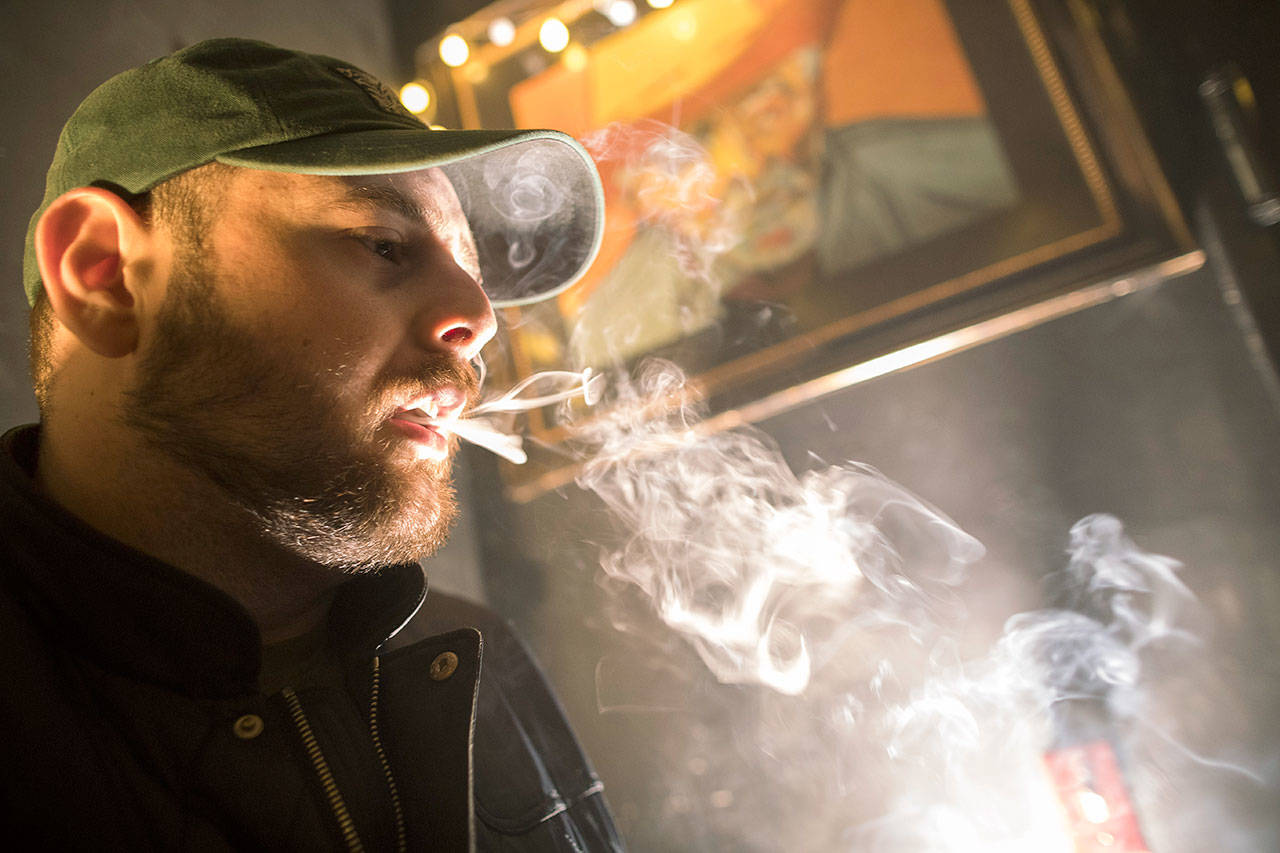 A man smokes marijuana at a Spleef NYC canna-cocktail party March 29 in New York. As more states make it legal to smoke marijuana, some government officials, researchers and others worry what that might mean for one of the country’s biggest public health successes: curbing cigarette smoking. (AP Photo/Mary Altaffer)