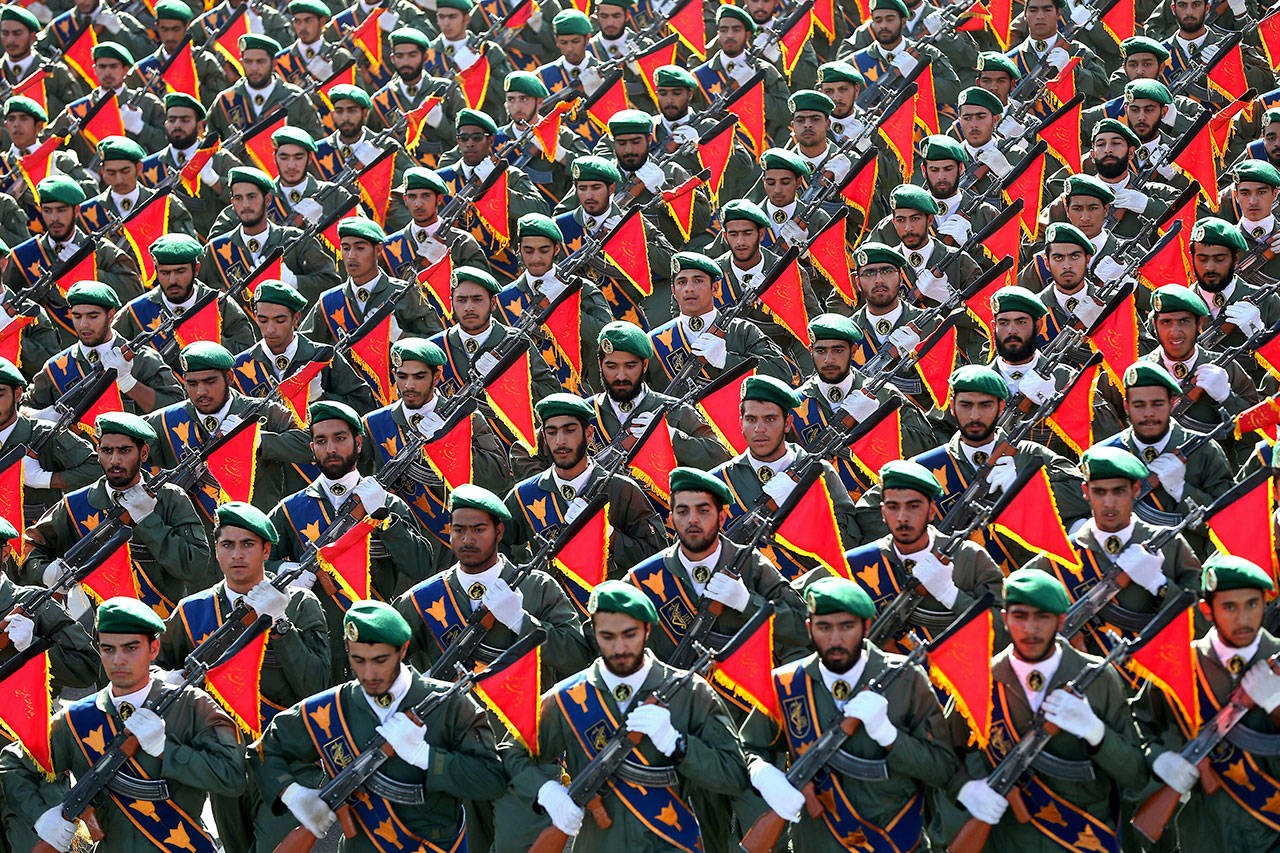 Iran’s Revolutionary Guard troops march in a military parade marking the 36th anniversary of Iraq’s 1980 invasion of Iran, in front of the shrine of late revolutionary founder Ayatollah Khomeini, just outside Tehran, Iran, on Sept. 21, 2016. The Trump administration is preparing to designate Iran’s Revolutionary Guards Corps a “foreign terrorist organization” in an unprecedented move that could have widespread implications for U.S. personnel and policy. (AP Photo/Ebrahim Noroozi, File)