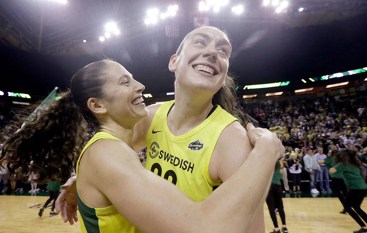 Seattle’s Breanna Stewart (right) is embraces by Sue Bird after the Storm defeated Phoenix to in Game 5 of the WNBA’s semifinal series on Sept. 4, 2018 in Seattle. (AP Photo/Elaine Thompson)
