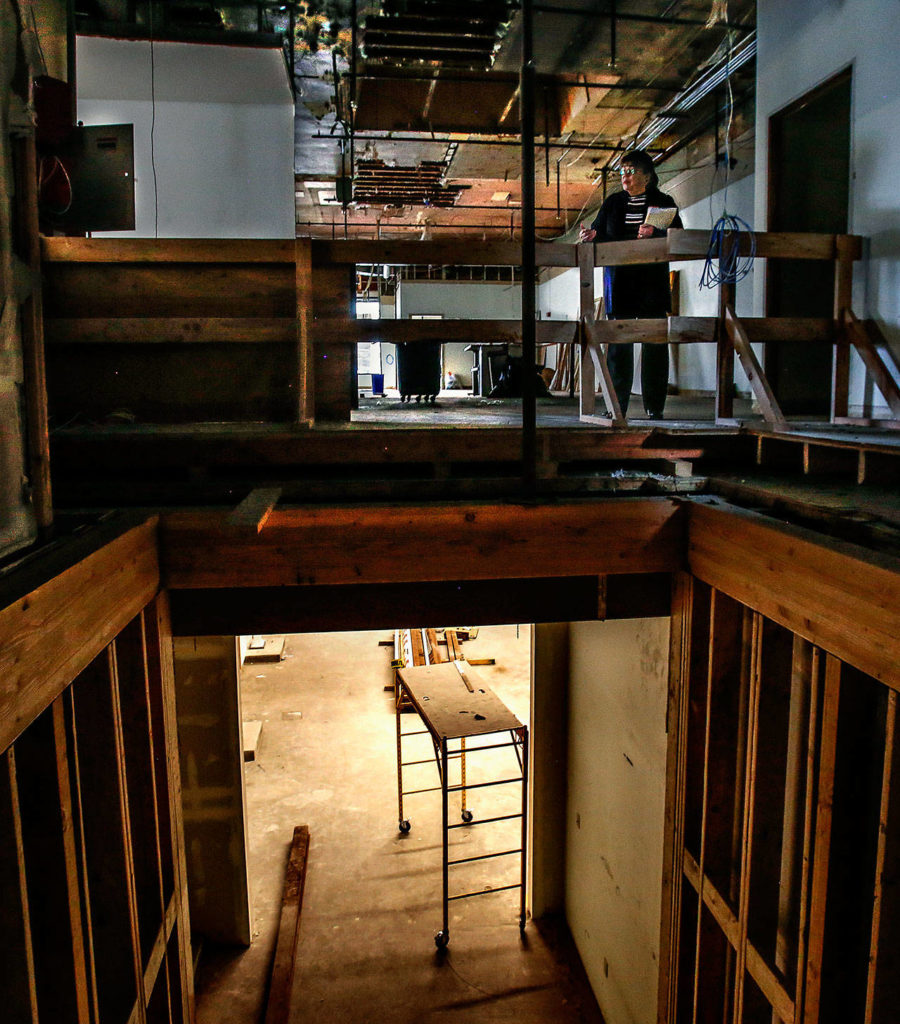 Everett Museum of History Executive Director Barbara George pauses near the top of an elevator shaft while looking around the museum’s Colby Avenue building. (Dan Bates / The Herald)
