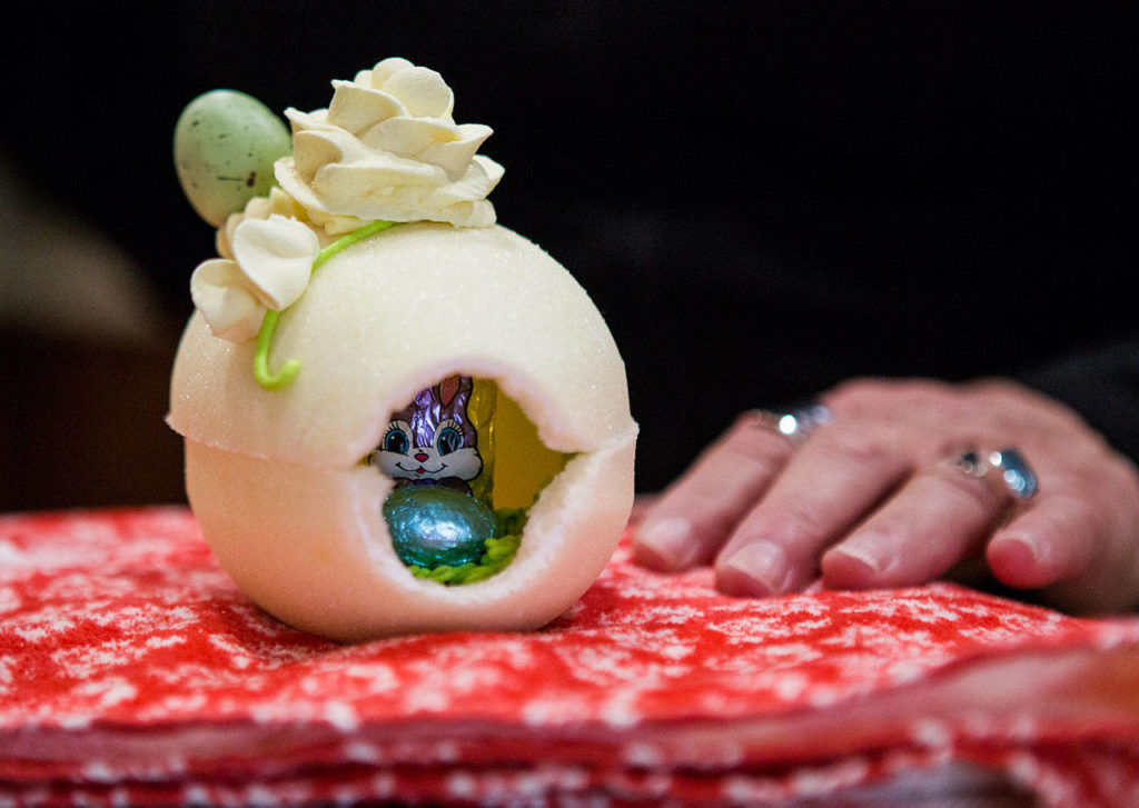 A chocolate bunny and egg are seen through the opening of a sugar egg. 
(Olivia Vanni / The Herald)
