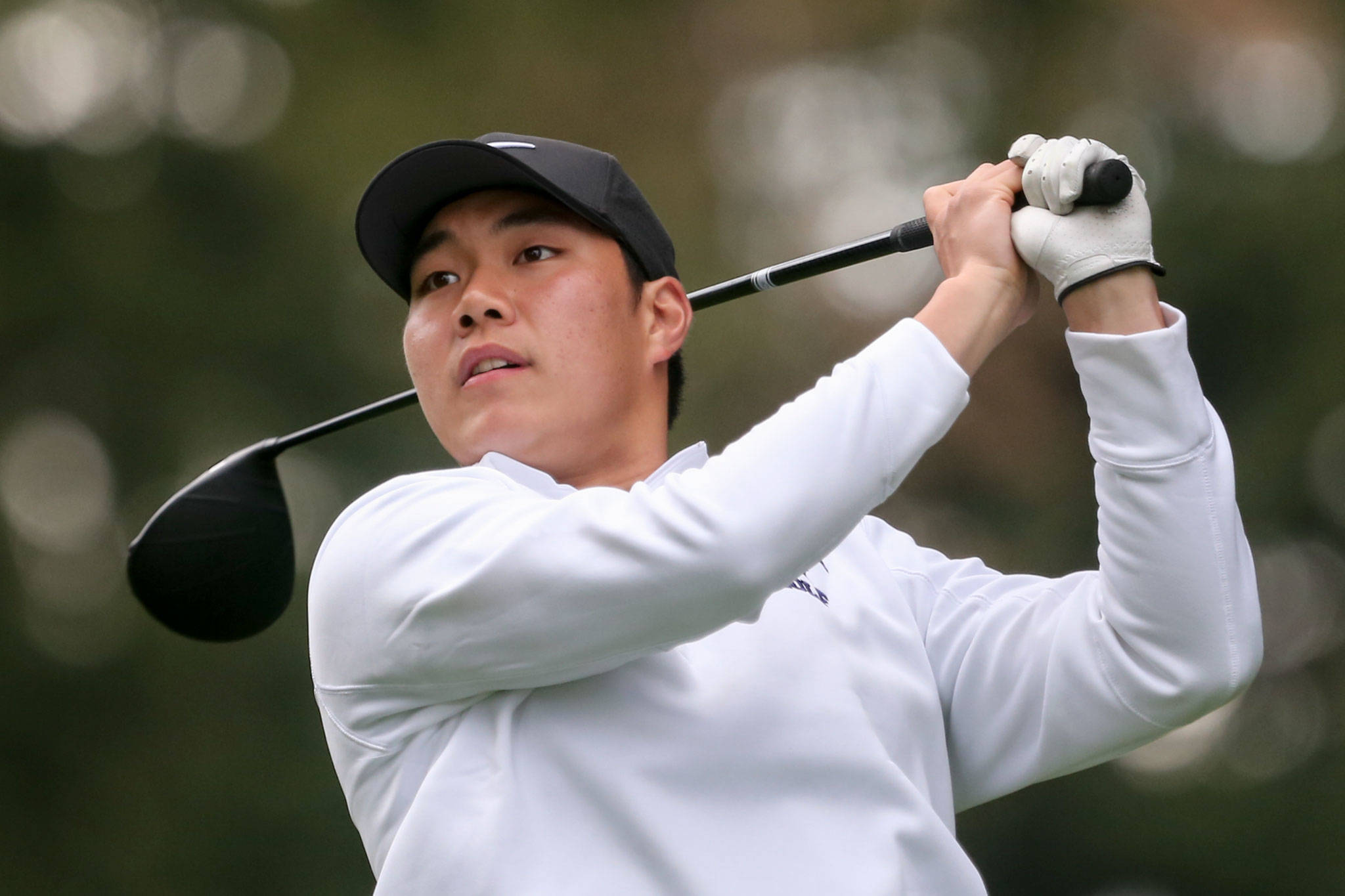 Kamiak’s Alvin Kim watches the ball after teeing off during the Tom Dolan Memorial Invitational golf tournament Monday afternoon at Everett Golf & County Club in Everett on April 8, 2019. Kim finished first with 67 and -5. (Kevin Clark / The Herald)