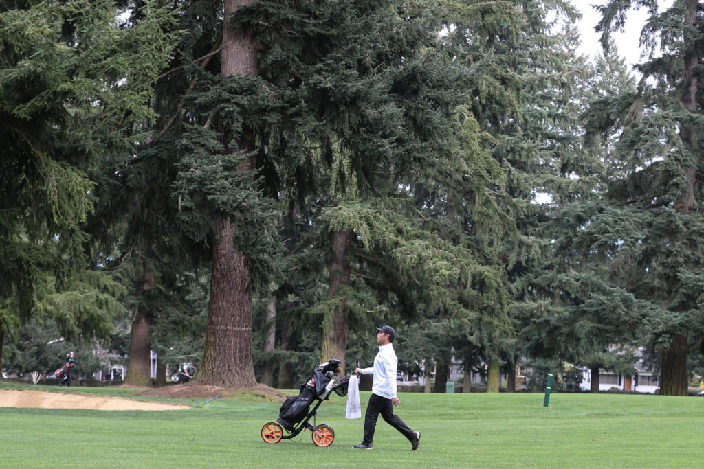 Kamiak’s Alvin Kwak makes his way down a green during the Tom Dolan Memorial Invitational golf tournament Monday afternoon at Everett Golf & County Club in Everett on April 8, 2019. (Kevin Clark / The Herald)
