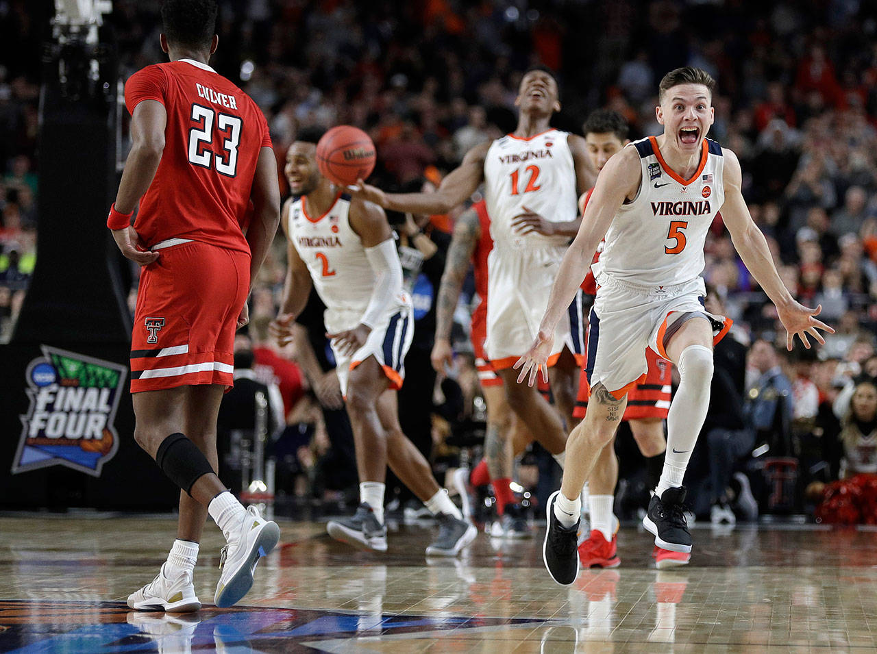 Virginia’s Kyle Guy (5) celebrates in front of Texas Tech’s Jarrett Culver (23) as the Cavaliers ran out the clock on their 85-77 overtime victory over the Red Raiders in the NCAA tournament championship game Monday in Minneapolis. (AP Photo/David J. Phillip)