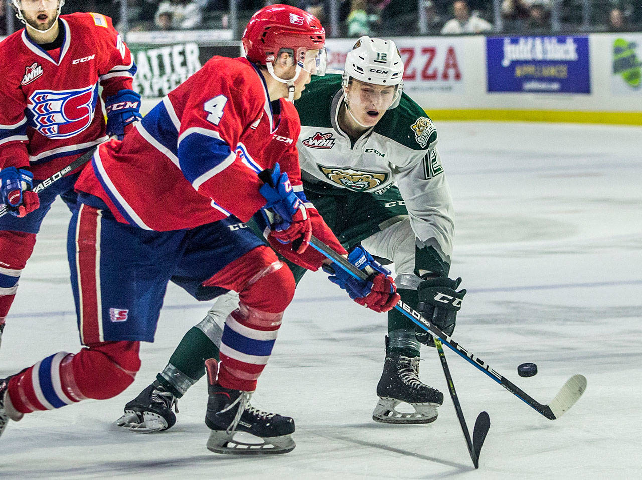 The Silvertips’ Max Patterson fights for the puck during a playoff game against the Chiefs on April 7, 2019, in Everett. (Olivia Vanni / The Herald)