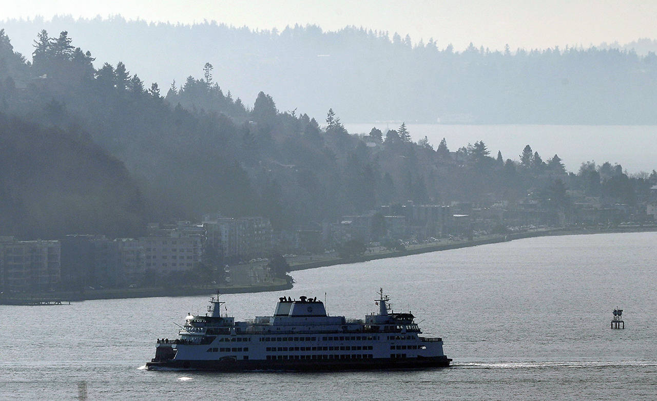 In this Dec. 31, 2018 photo, a Washington state ferry sails on a foggy day in Elliott Bay near West Seattle. (AP Photo/Ted S. Warren, file)