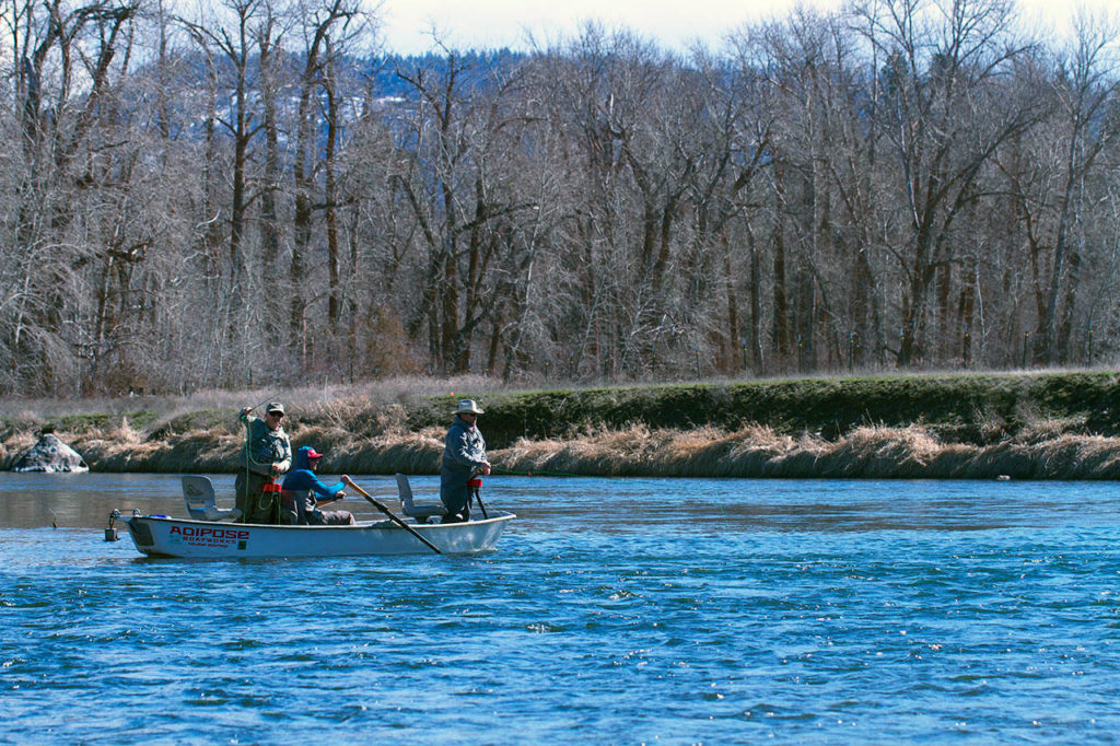 Paul Tetzlaff of Marysville and Les Bouck of Everett (both standing) drift flies along the upper Yakima River looking for trout. (Mike Benbow photo)
