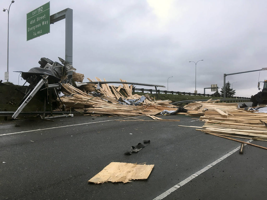 A truck lost a load of lumber after overturning on southbound I-5 near Pacific St. in Everett on Friday morning. (Sue Misao / The Herald)
