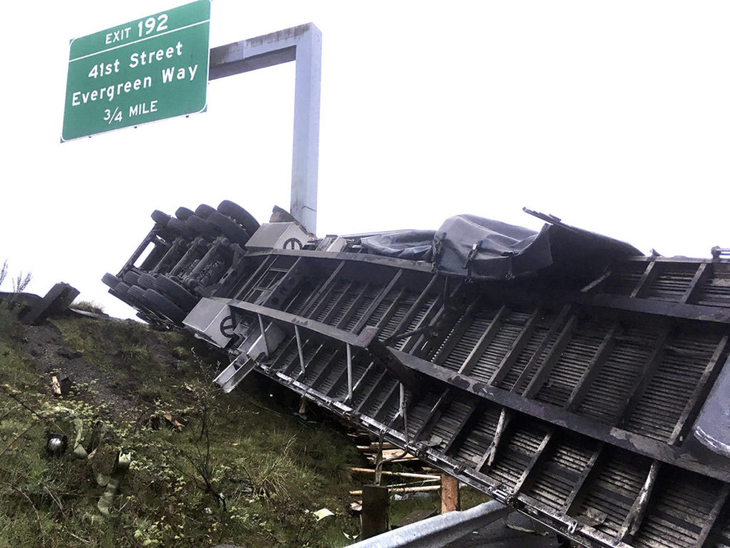 A truck lost a load of lumber after overturning on southbound I-5 near Pacific St. in Everett on Friday morning. (Sue Misao / The Herald)
