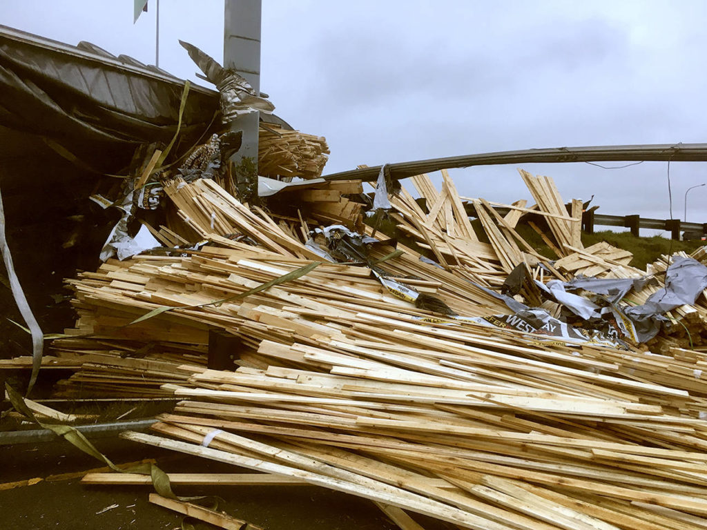 A truck lost a load of lumber after overturning on southbound I-5 near Pacific St. in Everett on Friday morning. (Sue Misao / The Herald)

