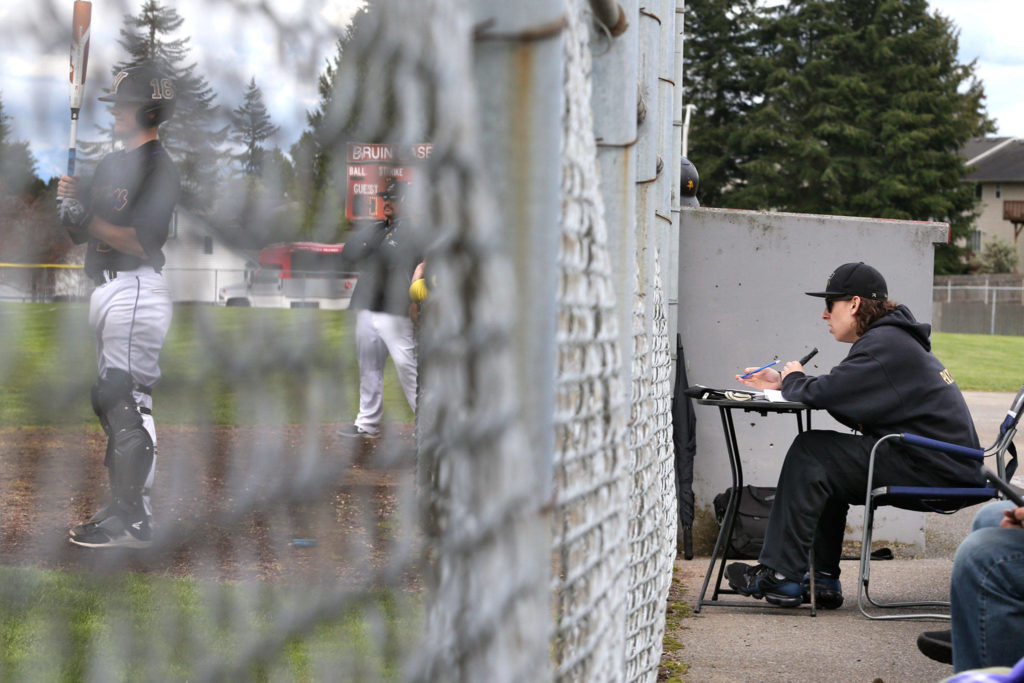 Set up just behind the fence near the Lake Stevens dugout, Payne Patchett gives a strikingly professional voice to the on-field action. (Kevin Clark / The Herald)
