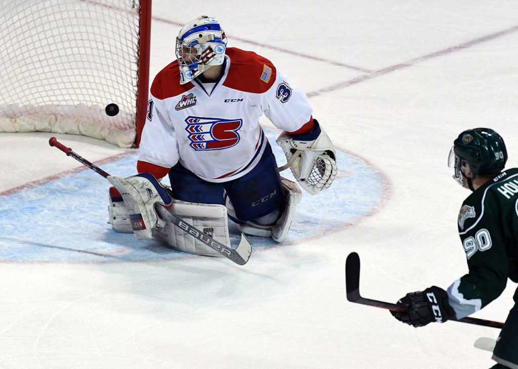 Silvertips forward Robbie Holmes (90) scores past Chiefs goaltender Bailey Brkin (31) during the first period of a playoff game on Friday in Spokane. (Colin Mulvany / The Spokesman-Review)
