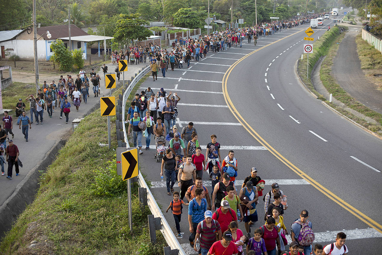 Central American migrants, part of the caravan hoping to reach the U.S. border, walk on the shoulder of a road in Frontera Hidalgo, Mexico, on Friday. (AP Photo/Isabel Mateos)