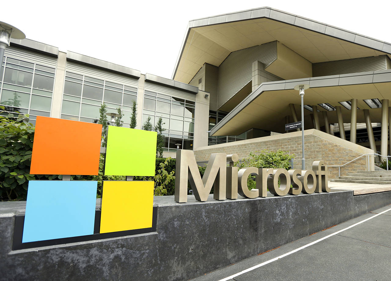 This 2014 photo shows Microsoft Corp. signage outside the Microsoft Visitor Center in Redmond. The Chelan County PUD is now the sole electricity provider for all of Microsoft’s campuses in the Puget Sound area, including its headquarters in Redmond. (AP Photo Ted S. Warren, File)
