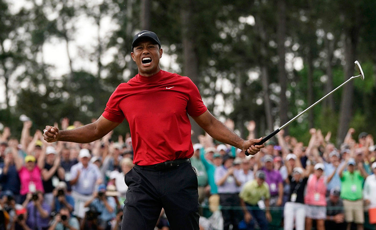 Tiger Woods reacts after winning the Masters golf tournament Sunday in Augusta, Georgia. (AP Photo/David J. Phillip)