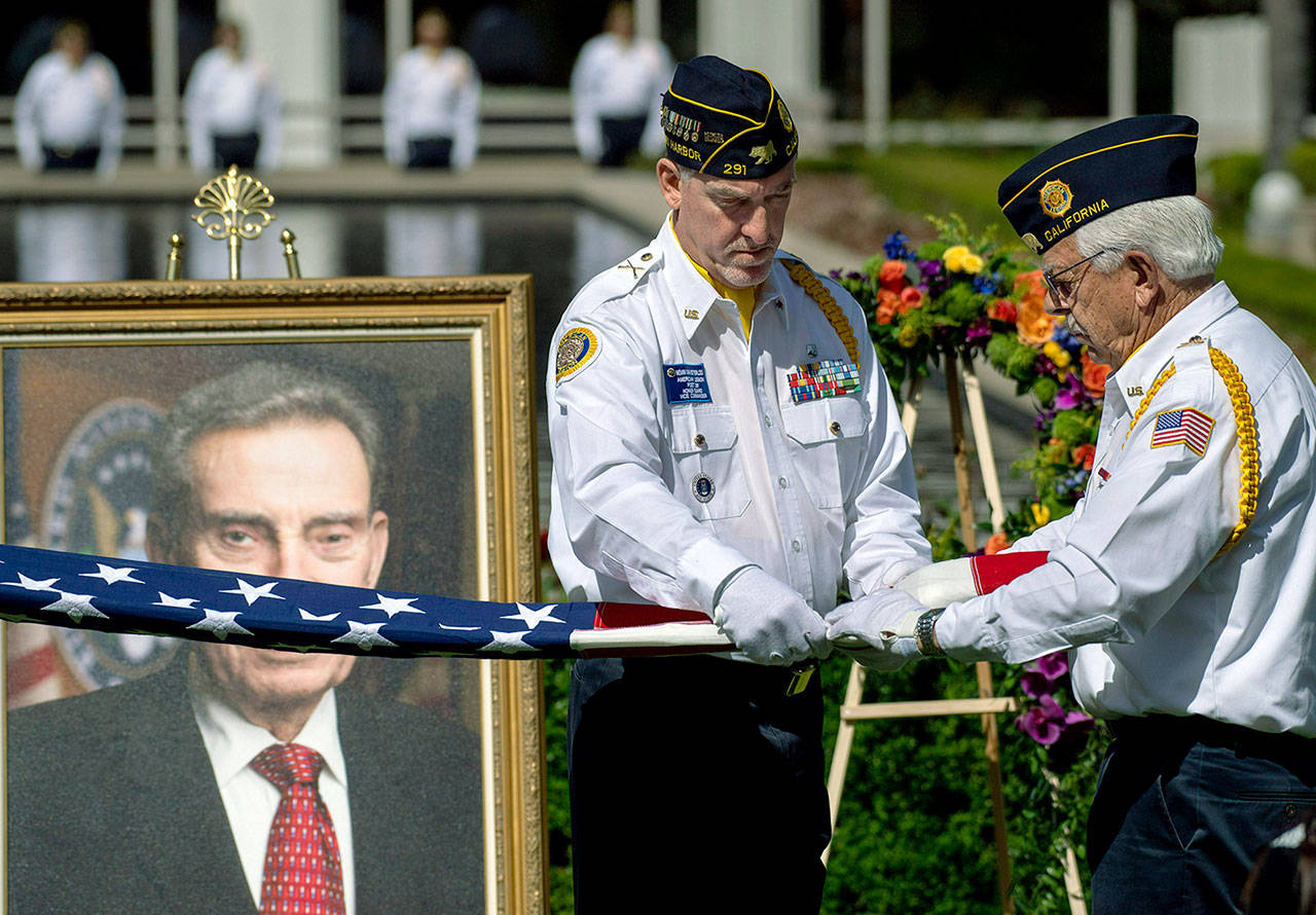 Members of Newport Harbor American Legion Post 291 fold the flag before presenting it to the grandchildren of Edward Nixon in Yorba Linda, California, on Sunday. (Mindy Schauer/The Orange County Register via AP)