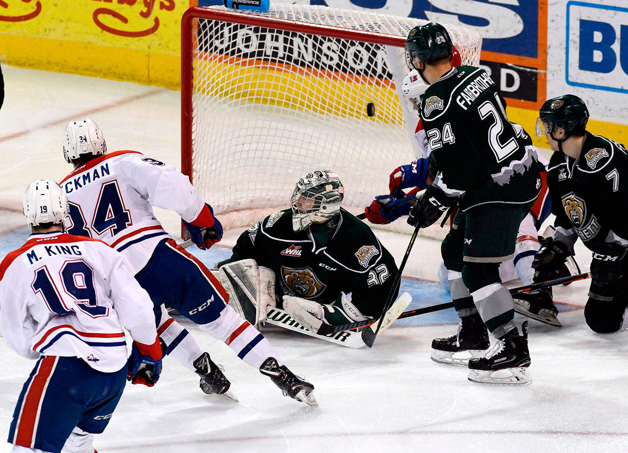 Chiefs forward Adam Beckman (34) scores the game-winning goal against Silvertips goaltender Dustin Wolf (32) during the third period of a playoff game on April 10, 2019, in Spokane. (Colin Mulvany / The Spokesman-Review)