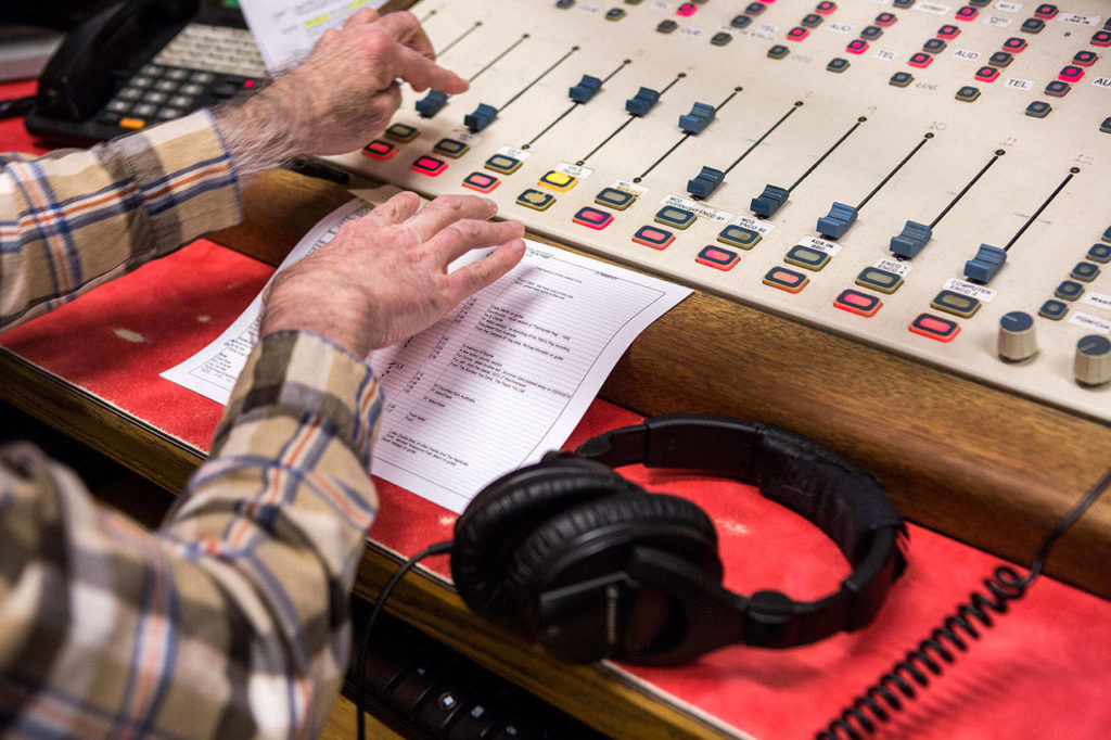 Jim Hilmar preps for an edition of	“Frettin’ Fingers,” which airs at 11 a.m. Saturdays on KSER-FM. (Olivia Vanni / The Herald)
