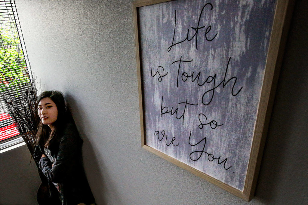 Gina Loh works as a prevention educator and in community outreach for Domestic Violence Services of Snohomish County. Encouraging words greet visitors at the agency’s new South County Advocacy Center. (Dan Bates / The Herald)

