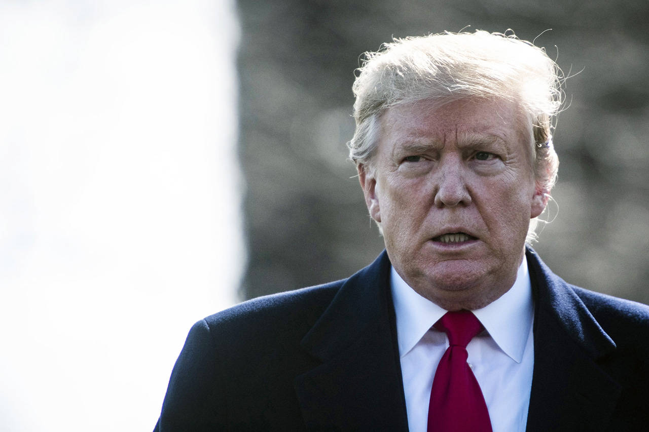 President Trump stops to talk to the media on the South Lawn of the White House while walking to Marine One in March. (Jabin Botsford/Washington Post)