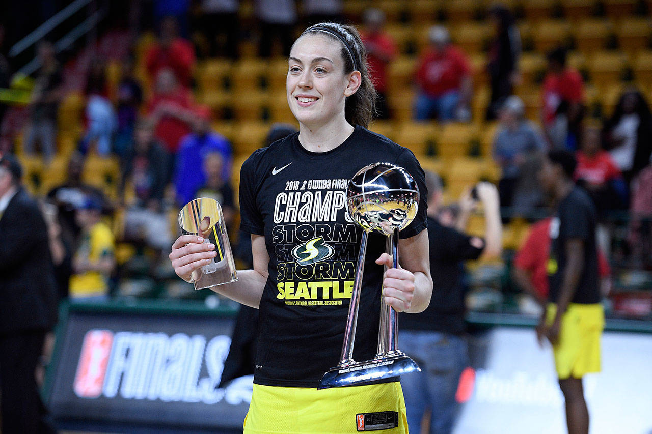 Seattle’s Breanna Stewart poses with the WNBA Finals MVP trophy and the WNBA championship trophy after the Storm beat Washington in a three-game sweep Sept. 12, 2018 in Fairfax, Virginia. (AP Photo/Nick Wass)