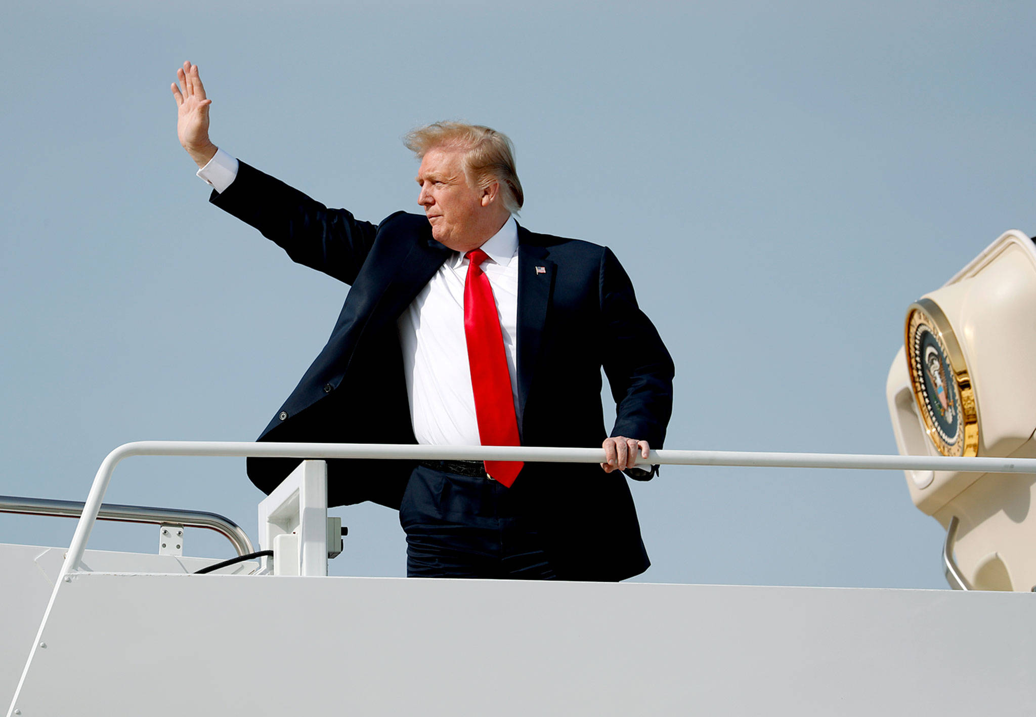 President Donald Trump waves while boarding Air Force One on Thursday at Andrews Air Force Base, Maryland, on his way to spend the Easter weekend at Mar-a-Lago in Palm Beach, Florida. (AP Photo/Pablo Martinez Monsivais)