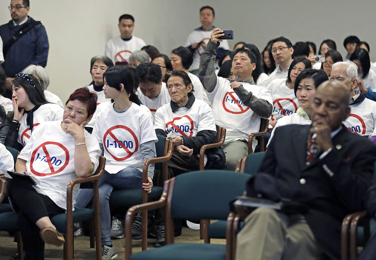 People opposed to Initiative 1000 wear T-shirts as they sit in the audience of a joint Washington state House and Senate committee Thursday at the Capitol in Olympia. (AP Photo/Ted S. Warren)
