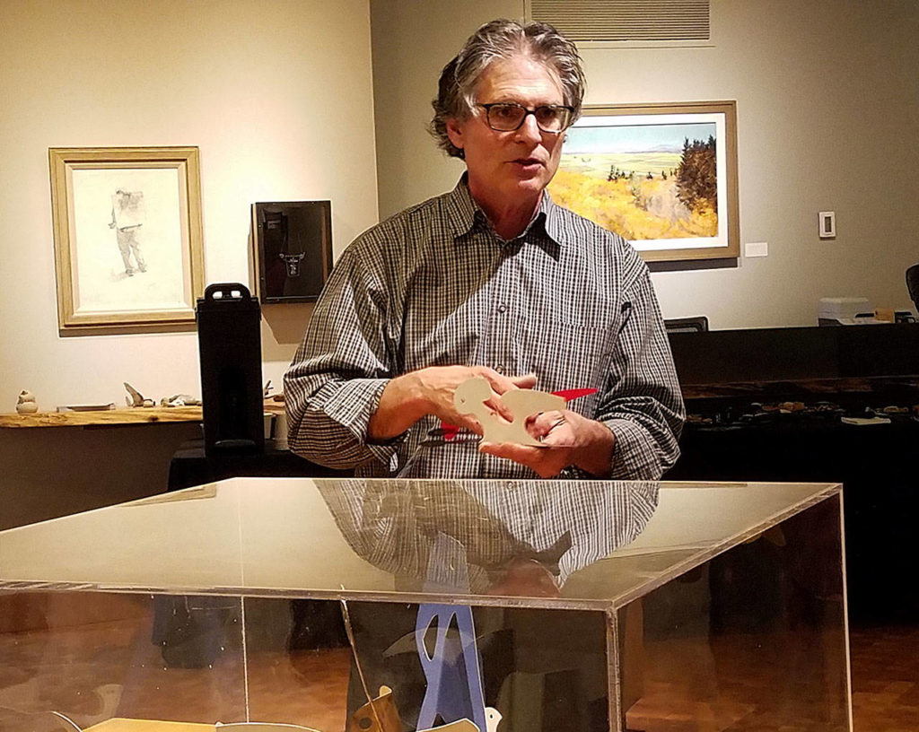 Gregory Kammer discusses his exhibit, “Between Seasons,” with members of an Everett Community College class. (Sharon Salyer/ The Herald)
