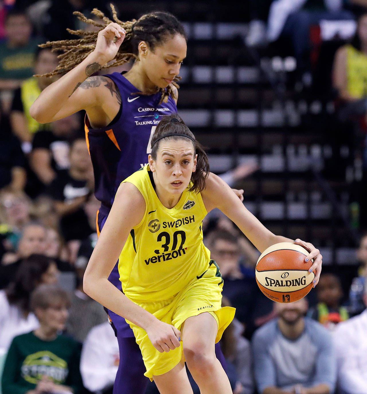 Seattle’s Breanna Stewart races ahead of Brittney Griner of Phoenix in the first half of a WNBA playoff last August in Seattle. (AP Photo/Elaine Thompson)