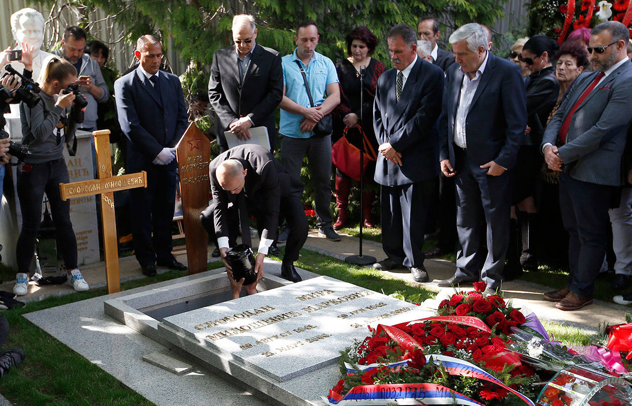 A family friend if Slobodan Bulatovic hands down the urn containing the ashes of Mirjana Markovic, the widow of former strongman Slobodan Milosevic during her funeral at the yard of his estate in his home town of Pozarevac, Serbia. Markovic died last week in Russia where she had been granted asylum. The ex-Serbian first lady had fled there in 2003 after Milosevic was ousted from power in a popular revolt and handed over to the tribunal in The Hague, Netherlands. (Associated Press)