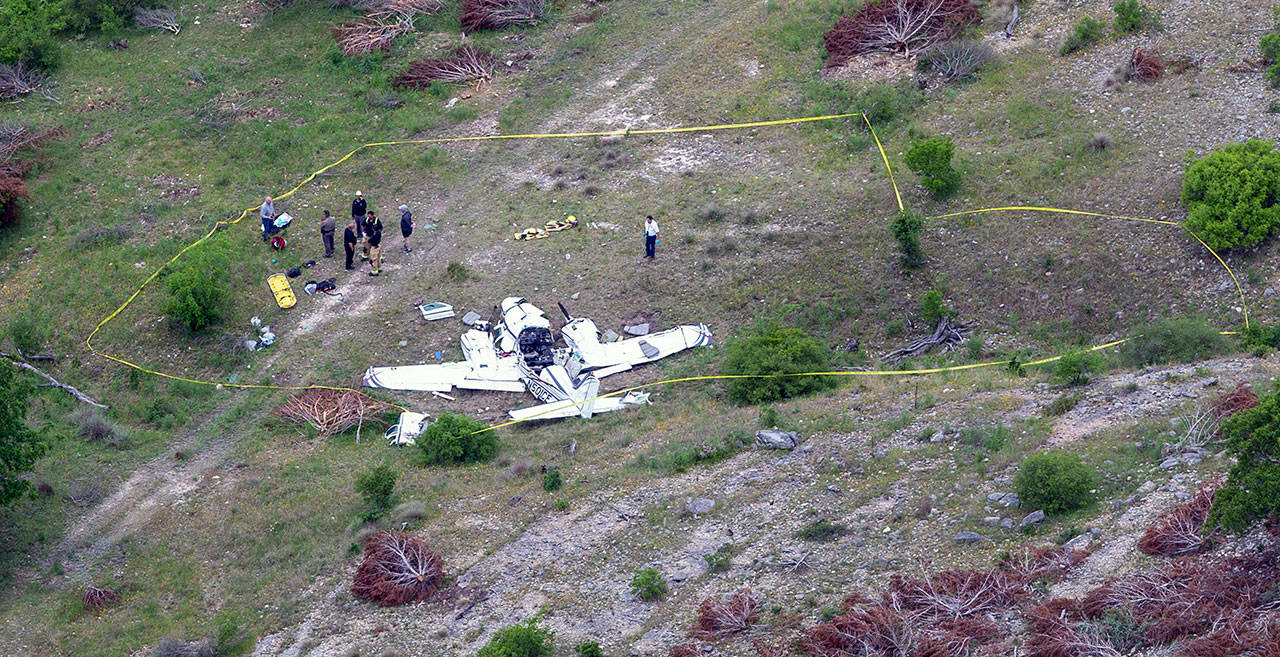 Authorities investigate at the crash scene of a twin-engine Beechcraft BE58 near Kerrville, Texas, on Monday. The pilot and the five other people aboard the plane were all killed, said Sgt. Orlando Moreno, a spokesman for the Texas Department of Public Safety. (William Luther/The San Antonio Express-News via AP)