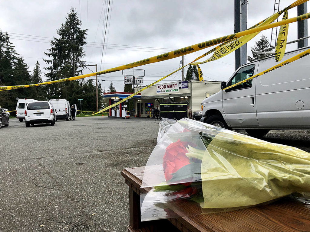 People had brought flowers to the scene Tuesday morning. (Caleb Hutton / The Herald)
