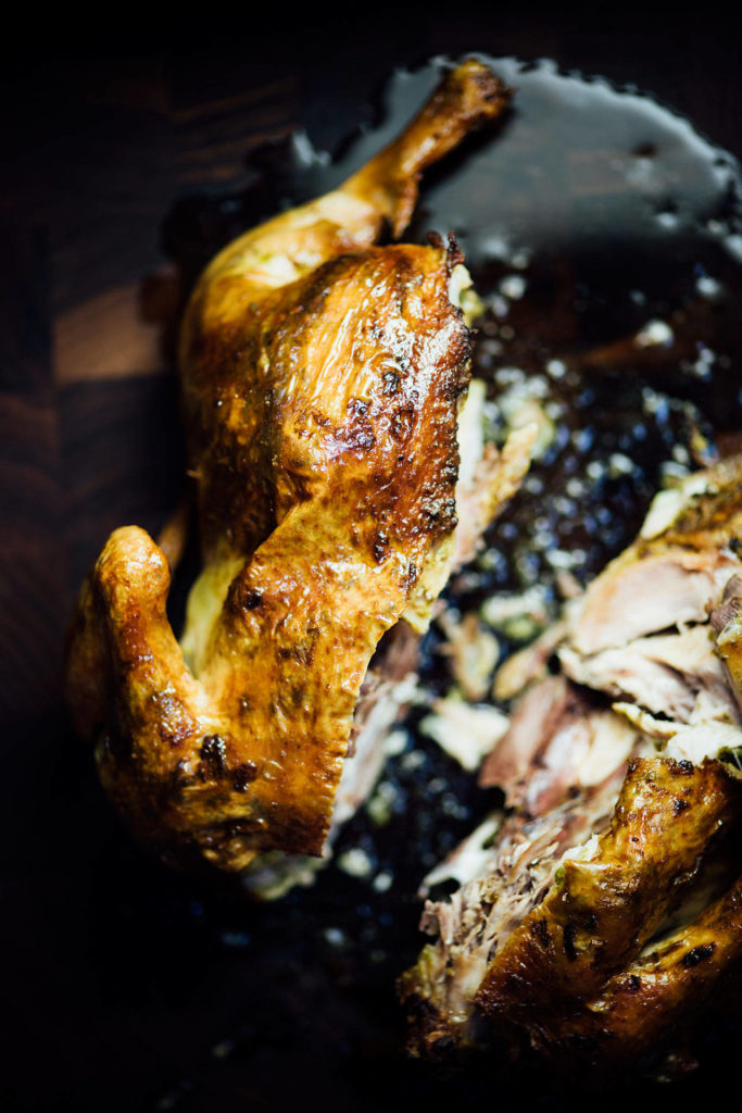 This roasted chicken is smothered in a hot green chutney. (Nik Sharma)
