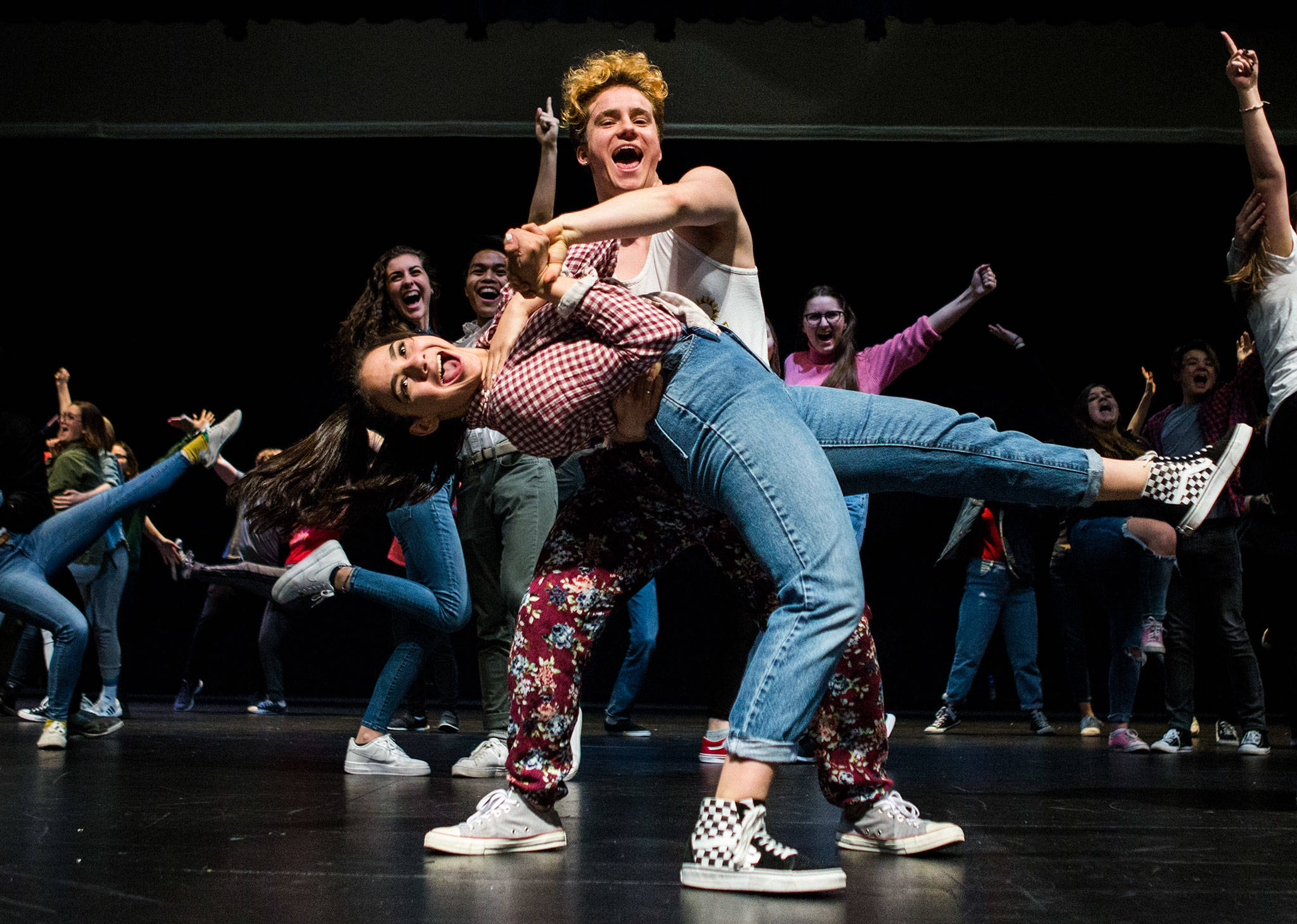 Toby Underhill, 17, who plays Ren McCormack and Natalie Mata, 15, as Ariel Moore, run through “The Finale” scene during a rehearsal of “Footloose” in the Everett Civic Auditorium. (Olivia Vanni / The Herald)