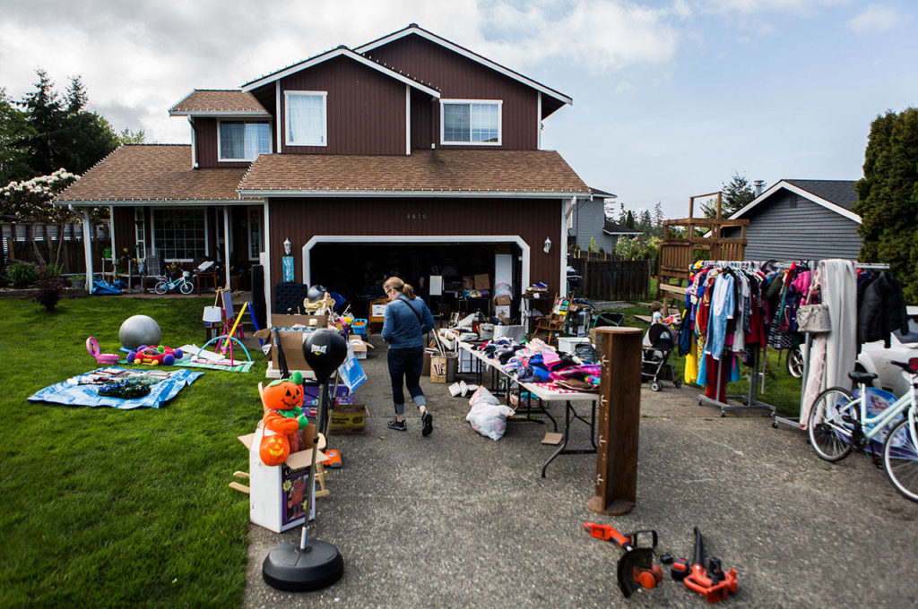 A customer walks through a garage sale at 4416 92nd St. SW on Friday in Mukilteo. (Olivia Vanni / The Herald)
