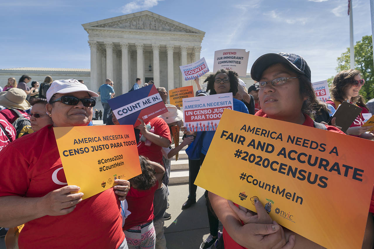 Immigration activists rally outside the Supreme Court as the justices hear arguments over the Trump administration’s plan to ask about citizenship on the 2020 census, in Washington on Tuesday. (AP Photo/J. Scott Applewhite)