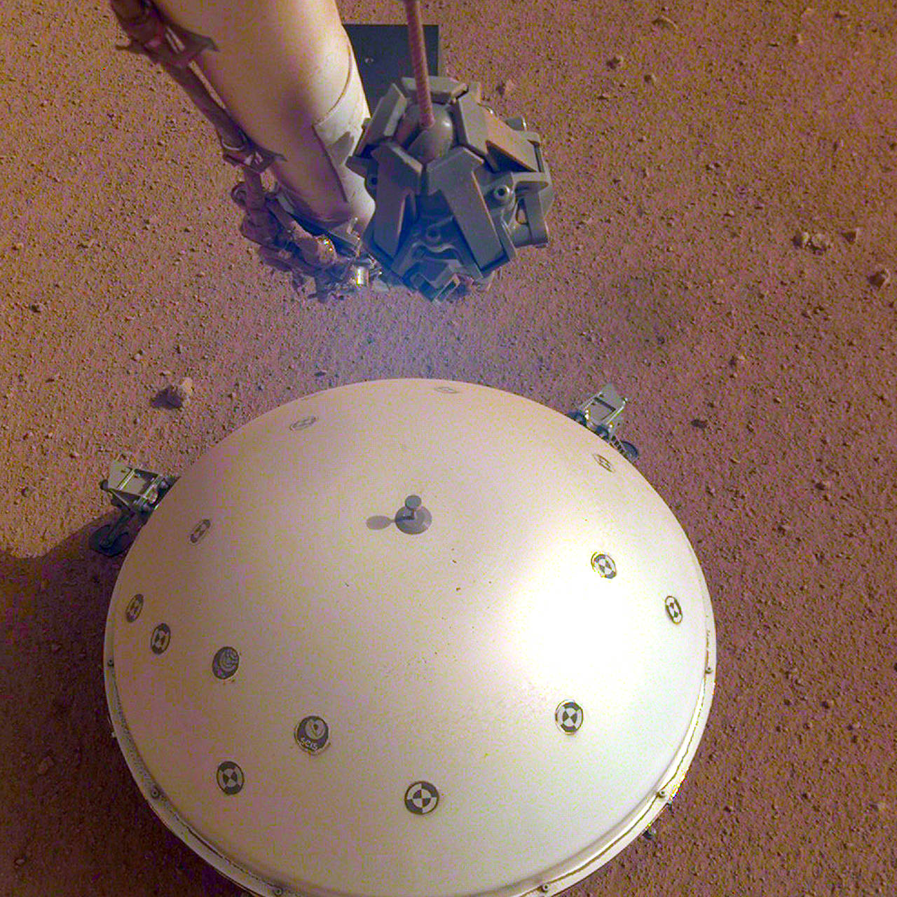 This photo shows the InSight lander’s domed wind and thermal shield which covers a seismometer on the 110th Martian day, or sol, of the mission. (NASA/JPL-Caltech via AP)