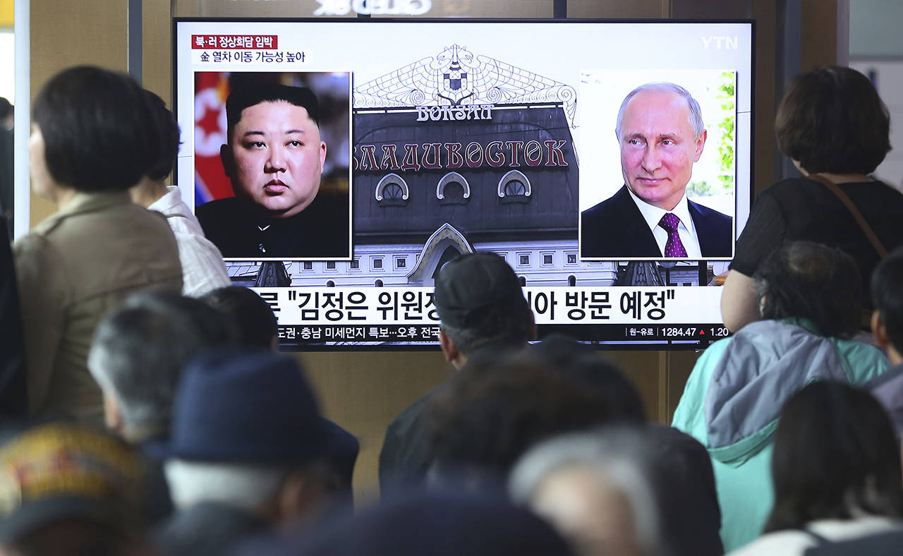 People watch a TV screen showing images of North Korean leader Kim Jong Un (left) and Russian President Vladimir Putin (right) during a news program at the Seoul Railway Station in Seoul, South Korea on Tuesday. (AP Photo/Ahn Young-joon)