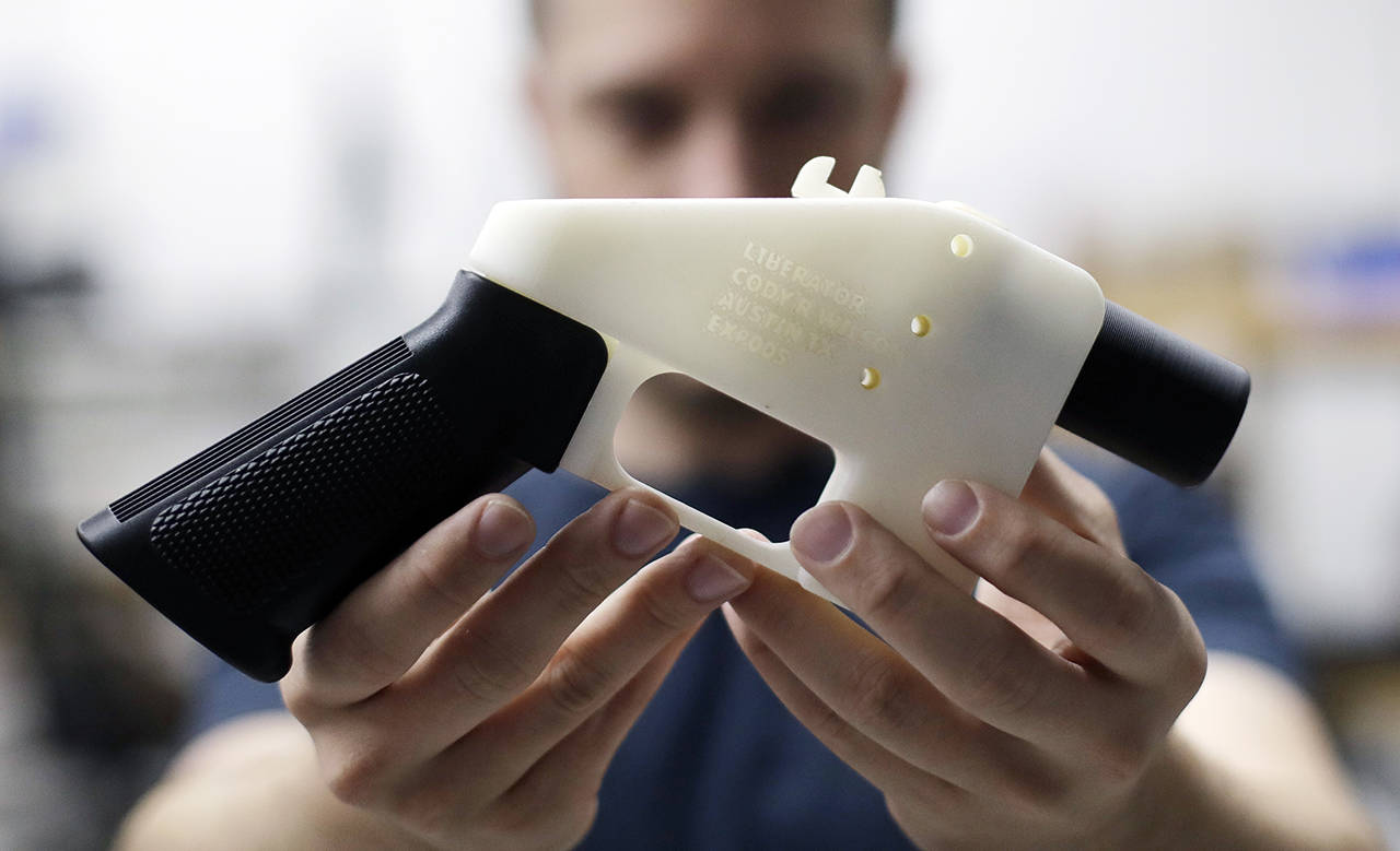 In this A2018 photo, Cody Wilson, with Defense Distributed, holds a 3D-printed gun called the Liberator at his shop in Austin, Texas. (AP Photo/Eric Gay, File)