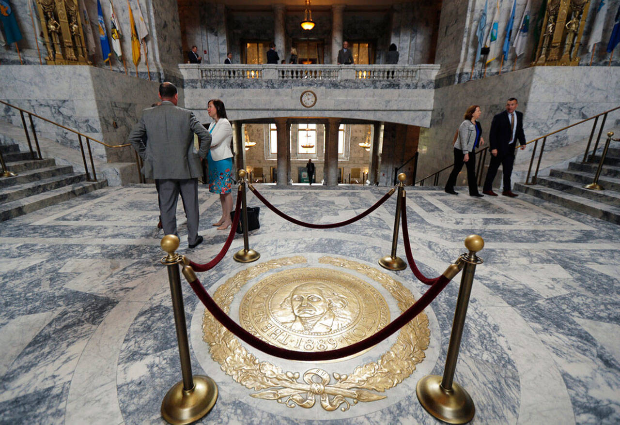 The Washington state seal is protected by ropes in the rotunda of the Legislative Building, Monday, at the Capitol in Olympia. Monday marked the start of the last week of the regular session of the Legislature. (Ted S. Warren / Associated Press)