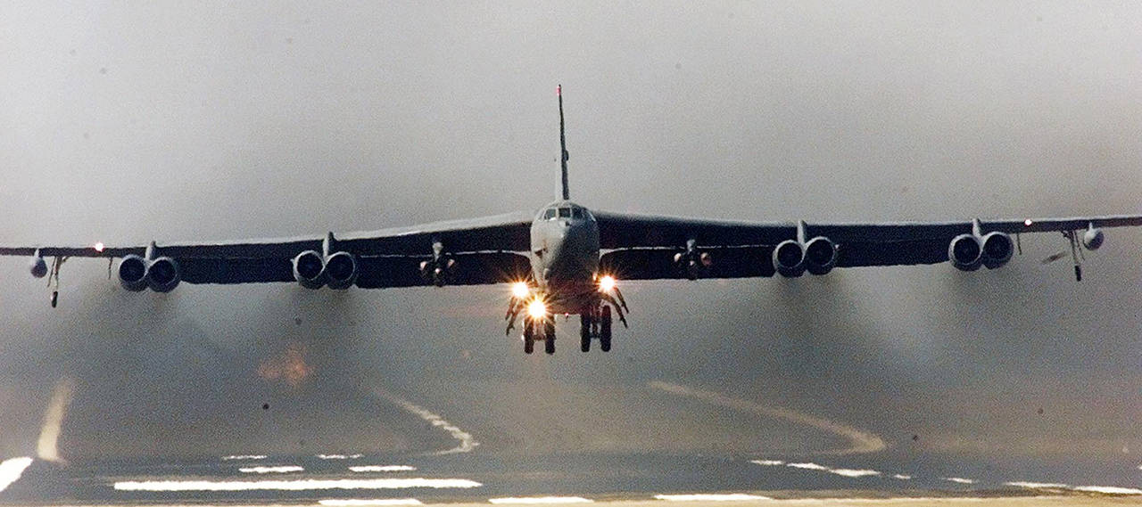 A U.S. Air Force B-52 bomber takes off in a cloud of smoke, on a mission over Iraq from RAF Fairford airbase, Western England in March 2003. (AP Photo/Max Nash)