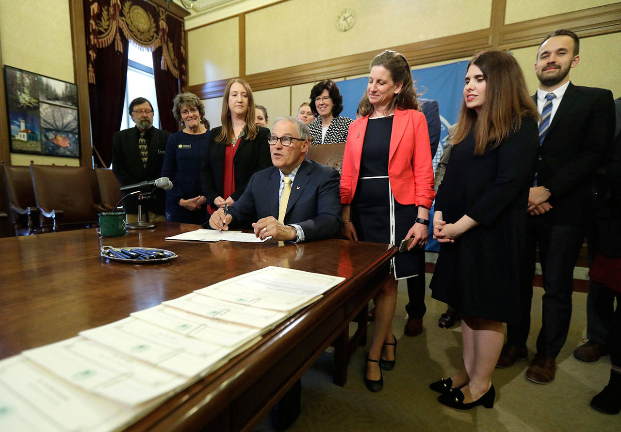 Washington Gov. Jay Inslee makes remarks before signing a bill into law Wednesday at the Capitol in Olympia. (AP Photo/Ted S. Warren)