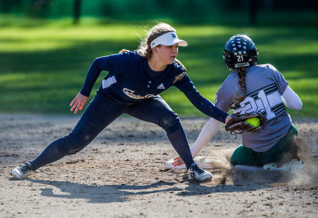Glacier Peak’s Harlee Carpenter (left) reaches to tag Jackson’s Kayla Peacocke as she slides into second base during a game at Jackson High School on April 24, 2019, in Mill Creek. (Olivia Vanni / The Herald)
