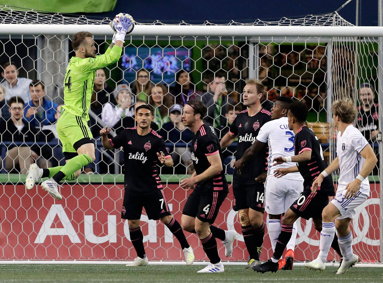 Sounders goalkeeper Stefan Frei (left) leaps to make a stop against the Earthquakes during the first half of an MLS match on April 24, 2019, in Seattle. (AP Photo/Ted S. Warren)