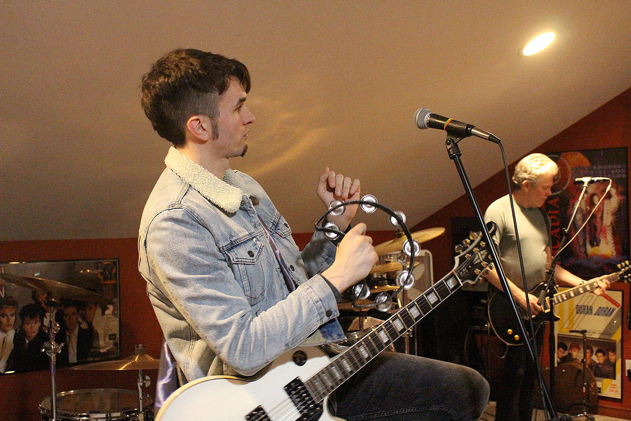 Michael Henrichsen performs “Cars” by Gary Numan at Galt’s Mukilteo home. (Madison Miller / Bothell-Kenmore Reporter)