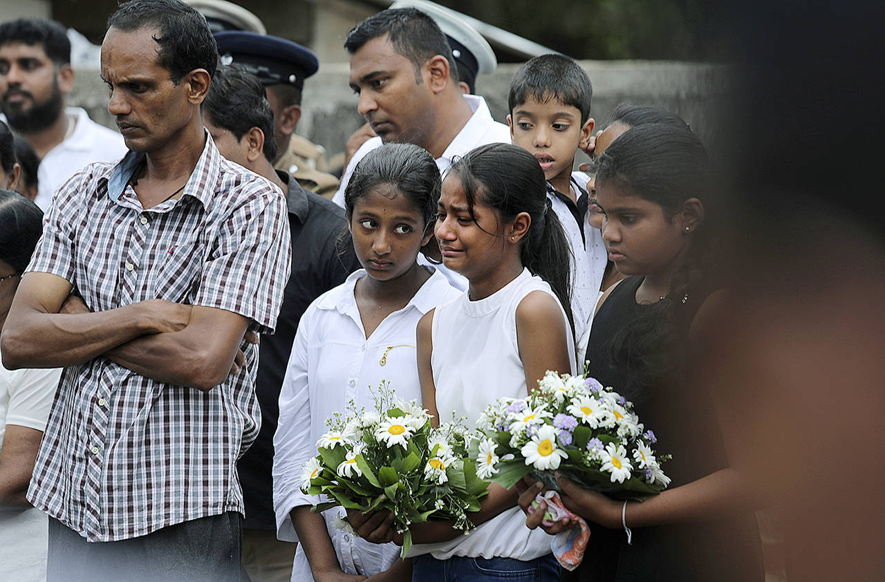 Friends of Dhami Brandy, 13, who was killed during Easter Sunday’s bomb blast at St. Sebastian Church, cry during a funeral service in Negombo, Sri Lanka on Thursday. (AP Photo/Manish Swarup)