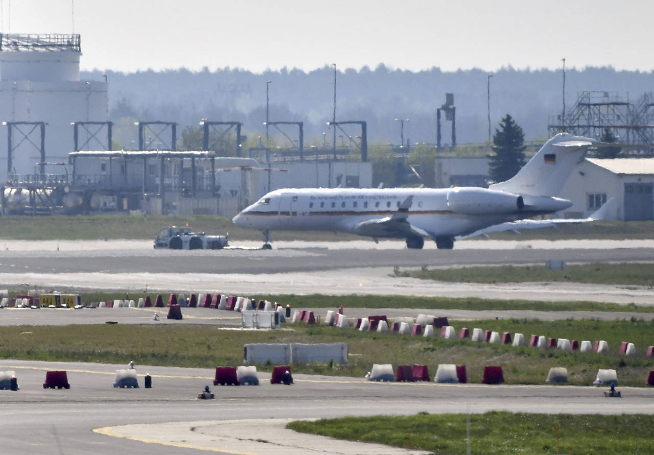 A Bombardier Global 5000 jet is being pulled over the tarmac by a truck at the airport Schoenfeld near Berlin, Germany on April 16. (Paul Zinken/dpa via AP)
